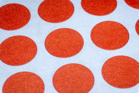 Array close-up of blank red circural multi purpose labels white background used in retail and 5s quality assurance for warning and attention drawing purpose.の写真素材