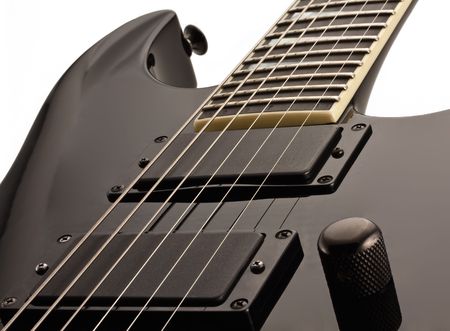 Black electro-guitar close-up isolated on whiteの写真素材