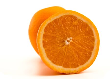 One half of orange isolated on whiteの写真素材