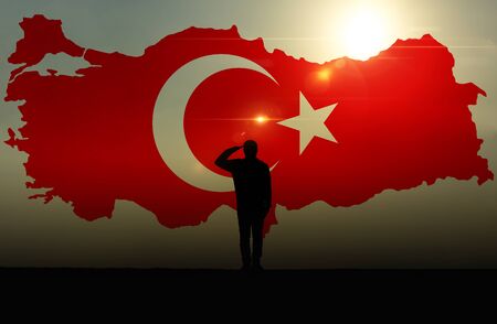 Silhouette of a man Saluting Against The Turkish Flagの写真素材