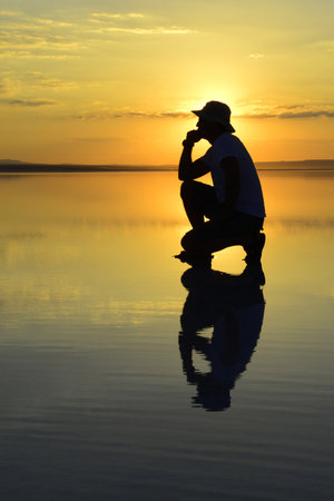 sunset meditation and reflection. Sunset, Salt Lake Aksaray, Turkey.の写真素材