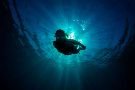 Free diving modeling. Blue background.