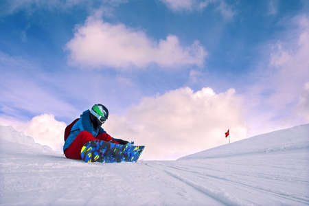 Girl snowboarding in the mountains on the snowboard.の写真素材