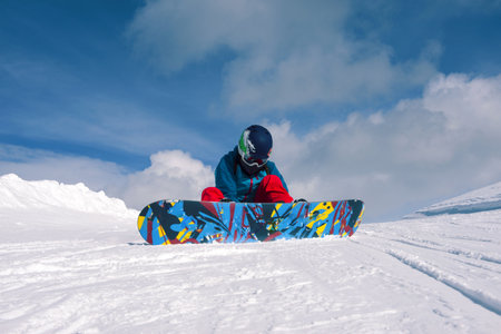 Girl snowboarding in the mountains on the snowboard.の写真素材