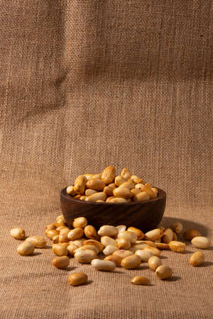 peeled peanuts on fabric background