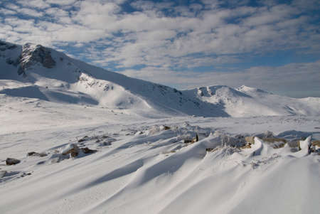 snow floor, snow texture, snowy peaks in cold sunny weather, cloudy snow landscape. Windblown snow texture. Uludag, National Park, Bursa Turkey.の写真素材