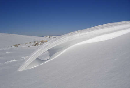 snow floor, snow texture, snowy peaks in cold sunny weather, cloudy snow landscape. Windblown snow texture. Uludag, National Park, Bursa Turkey.の写真素材