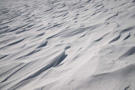 snow floor, snow texture, snowy peaks in cold sunny weather, cloudy snow landscape. Windblown snow texture. Uludag, National Park, Bursa Turkey.の写真素材