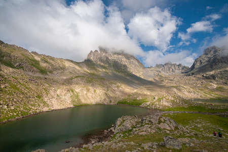 Lakes formed when the snow melted in a spring weather with white clouds in the blue sky. Lakes...