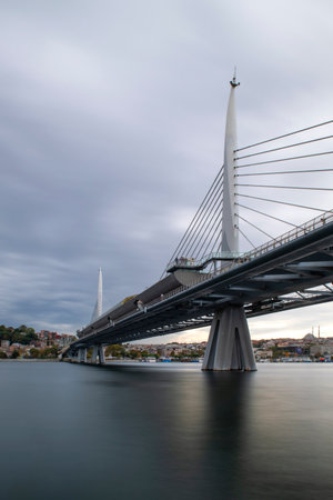 long exposure. View of HaliÃ§ Metro Bridge connecting AzapkapÄ± (BeyoÄlu) and UnkapanÄ± (Fatih) (Halic Metro Bridge). blue sky Istanbul Turkeyの写真素材
