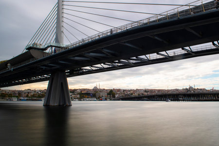 long exposure. View of HaliÃ§ Metro Bridge connecting AzapkapÄ± (BeyoÄlu) and UnkapanÄ± (Fatih) (Halic Metro Bridge). blue sky Istanbul Turkeyの写真素材