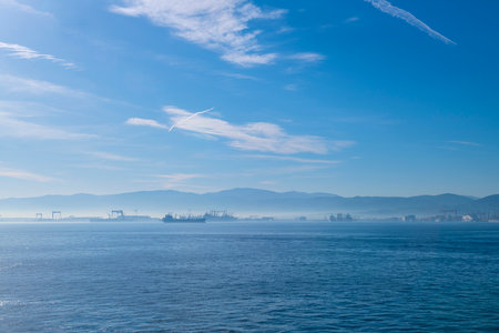 Seascape with ship and city in the blue sky background.の写真素材