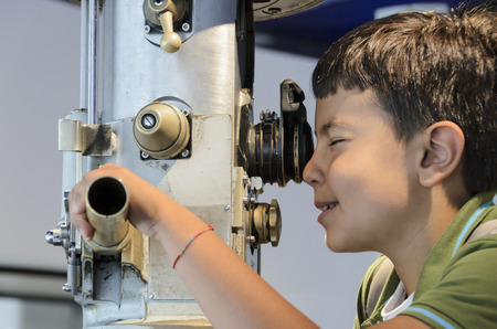 Curious child looking through the periscope the external environment.