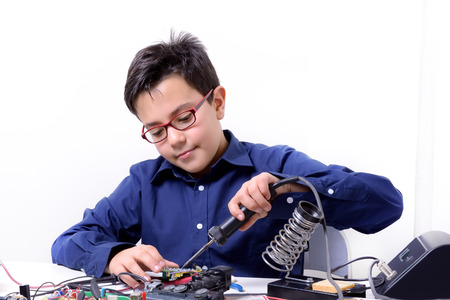 Young student performs experiments in electronics and dreams of the future.の写真素材