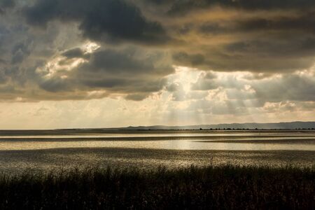 Sunset in the lagoon, where fishermen return to the approach of the impending storm. Dawning. Mediterranean islands.の写真素材
