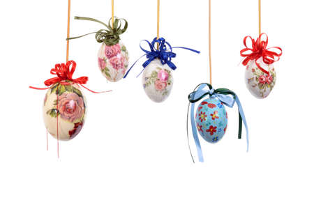 Colorful Easter eggs with flowers and handcrafted by hand. Ribbons and white background.の写真素材