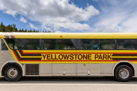 Yellowstone National Park, Wyoming, USA - May 31, 205: Close up of sign for Yellowstone Park on side of Tour Bus.Bus parked at the Mud Volcano Area on the Grand Loops Road in Yellowstone National Park in Wyoming.のeditorial素材