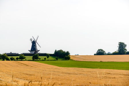 Characteristic windmills in the countryside of Denmark in summer.