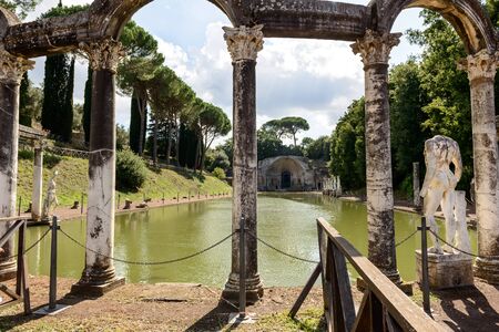 Ancient ruins of Villa Adriana(Canopus, canal pool surrounded by columns and statues), Tivoli, Italyの写真素材