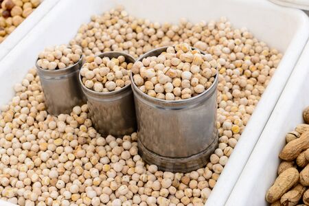 Close Up of the sales counter of peanuts with small tin cans.の写真素材