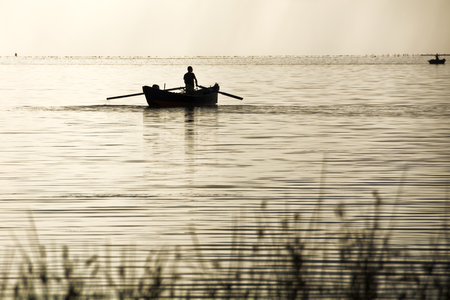 Sunset in the lagoon, where fishermen return to the approach of the impending storm. Dawning. Mediterranean islands.の写真素材