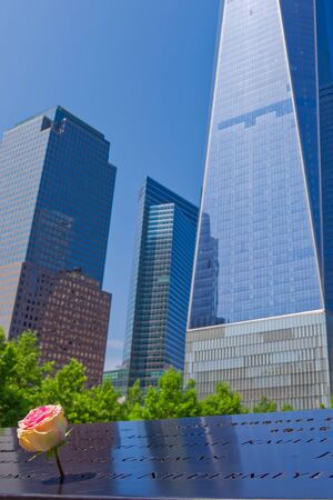 New York, USA - June 08, 2015: South pool memorial commemorating the victims of the 11 september terror attack in 2001. New York architecture in the background.のeditorial素材