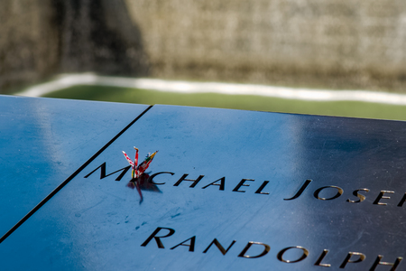 New York, USA - June 08, 2015: South pool memorial commemorating the victims of the 11 september terror attack in 2001. New York architecture in the background.のeditorial素材
