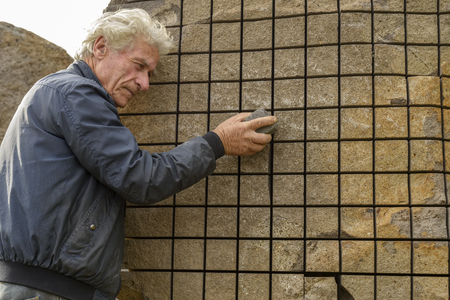 San Sperate, Italy, Sardinia - April 22, 2014: Italian muralist and sculptor Pinuccio Sciola in his village of San Sperate in Sardinia. Location: San Sperate, Sardinia, Italy.のeditorial素材