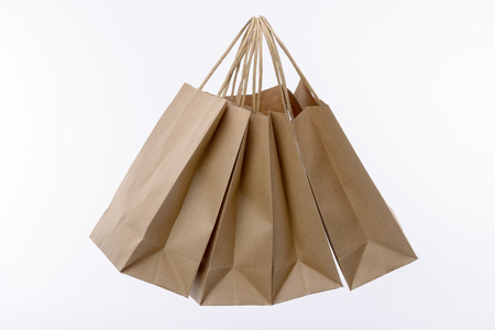 Variety of colored paper shopping bags on white background. Empty area.の写真素材