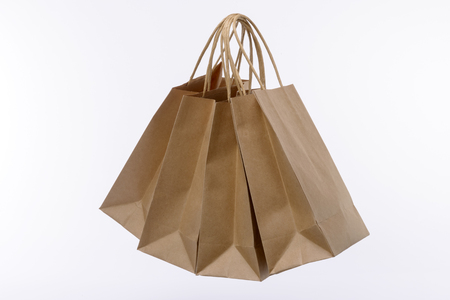 Variety of colored paper shopping bags on white background. Empty area.の写真素材
