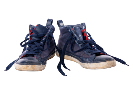 Old worn blue boy shoes isolated on white background.の写真素材