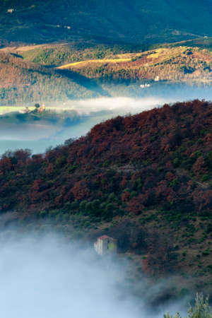 Landscape of valley in Umbria in autumn with sunrise and fog.の写真素材