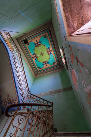 Interior of a decaying abandoned house. Art nouveau colors. Window openings. Mystery and darkness. long exposure times.のeditorial素材