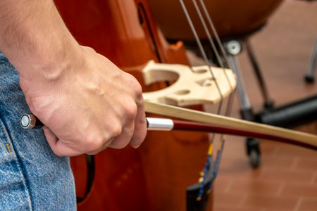 Real life young music students during rehearsals. Musical instruments and music stands with staves....