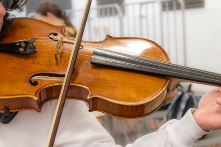 Real life young music students during rehearsals. Musical instruments and music stands with staves....