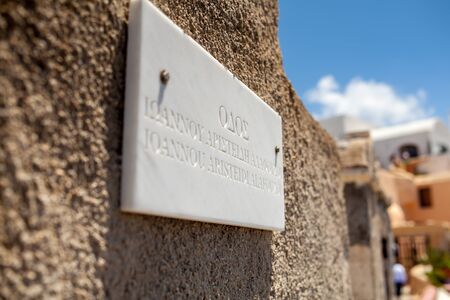 Thira, Greece - 05/20/2015: Sign with the name of the place on one of the walls of the city of Thiraのeditorial素材