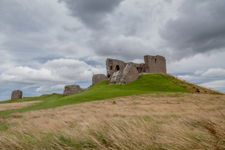 Duffus Castle on top of the hill with a cloudy skyの写真素材