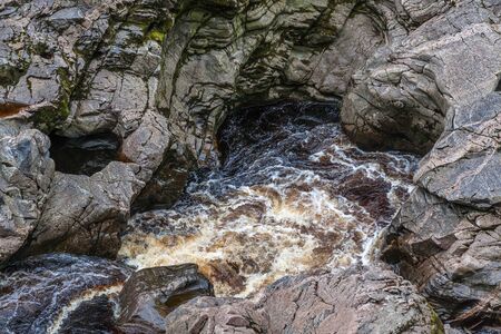 dark brown water of Findhorn riverの写真素材