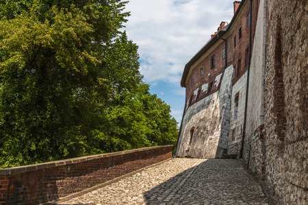Wawel castle fortification on a sunny day with trees and blue skyのeditorial素材