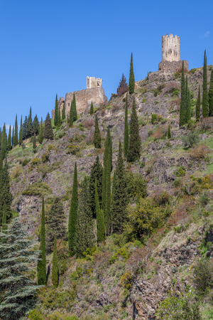 Lastrous castle in France on top of the mountain on a sunny day with trees and pathのeditorial素材