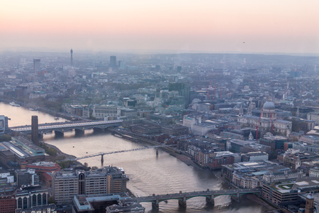 a view of Thames river and London at sunset with red sky and air pollutionの写真素材