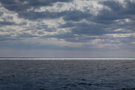 blue cloudy and stormy sky with mediterranean seaの写真素材