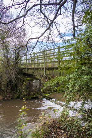 a bridge across Rother river with green trees and blue skyの写真素材