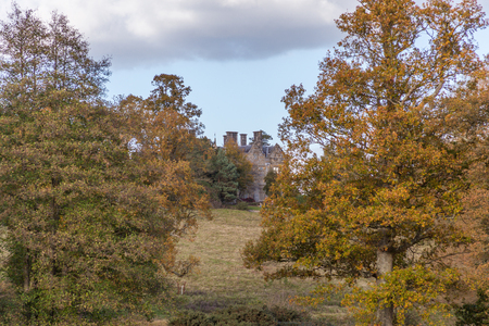 a view of Scotney Castle on a top of hill surrounded by atumn treesのeditorial素材