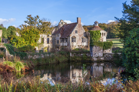 a reflection of Old Scotney castle in moat waters on a sunny dayのeditorial素材
