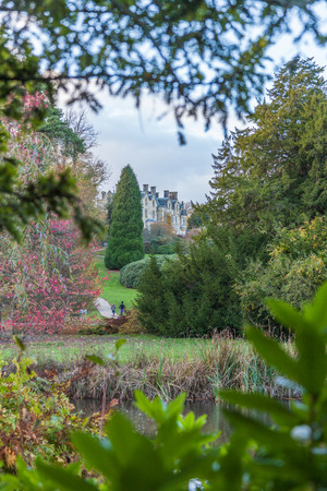 a view of Scotney Castle on a top of hill surrounded by atumn treesのeditorial素材