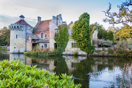a reflection of Old Scotney castle in moat waters on a sunny dayの写真素材