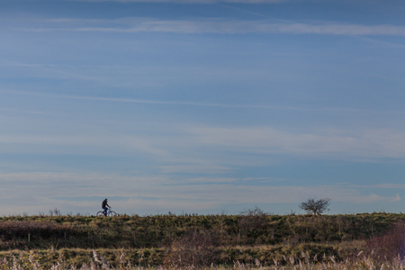 a cyclist on horizon of Rainham marshesの写真素材