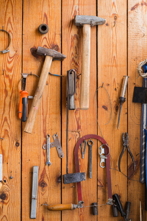 Carpentry tools hanging on the wooden wallの写真素材