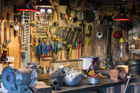 Motorcycle parts and tools on the desktop in the garageの写真素材